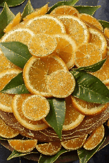 sliced oranges and green leaves on a plate