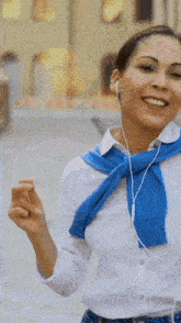 a woman wearing ear buds and a blue scarf has the word boom on her wrist