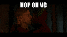 a man is kissing another man with the words hop on vc written above him
