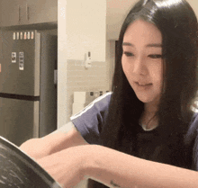 a woman in front of a refrigerator with a sticker on it that says ' a ' on it