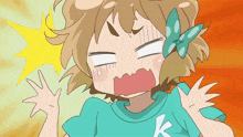 a girl in a blue shirt with the letter k on it is making a funny face