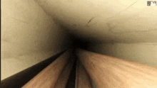 a narrow tunnel with a mlb logo on the bottom