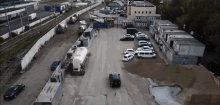 an aerial view of a parking lot with cars parked
