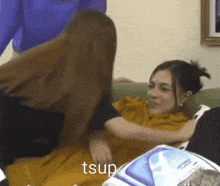 a woman laying on a couch with the word tsup on the bottom right