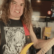 a man with long curly hair is playing a guitar in front of a television that says bradleyhallow on it