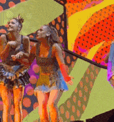 a group of women are dancing on a stage with a colorful background