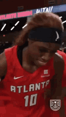 a basketball player wearing a red jersey that says atlanta 10 on it