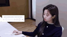 a woman is sitting at a desk with a computer mouse and a sign that says ' circles ' on it