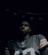 a blurry image of a person in a dark room with a light behind them