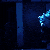 a man and a woman are dancing in a blue light