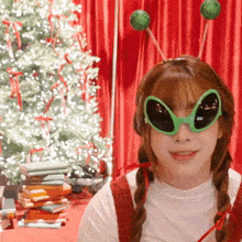 a woman wearing green alien glasses and antennas