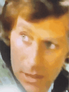 a close up of a man 's face with a very blurry background