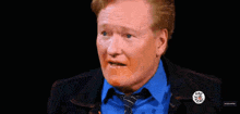 a man in a blue shirt and tie is saying i 'm perfectly fucking fine