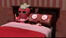 a stuffed strawberry and a stuffed chocolate bar are laying in bed .