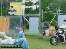 a man sits on a bench next to a motorcycle