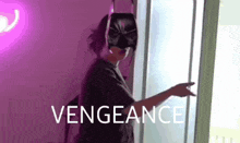 a woman wearing a batman mask is standing in front of a window and pointing .