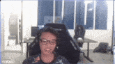 a man wearing glasses and headphones is sitting in a chair with the word yukino on the bottom