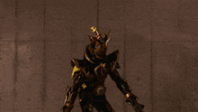 a man in a black and gold armor is holding a sword and a gun
