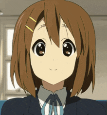 a close up of a girl 's face with brown hair and big eyes