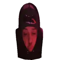 a person wearing a black hoodie with a red mouth