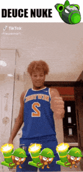 a man in a blue jersey with the letter s on it gives a thumbs up