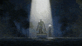 a statue of a man in a green robe is lit up by a spotlight