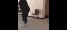 a person is standing next to a chair in a room .
