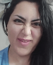 a close up of a woman making a funny face with her mouth open .