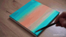 a person is painting on a canvas with the words made in animotica below them