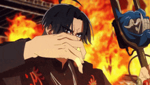 a cartoon character covering his face with his hand in front of a fire