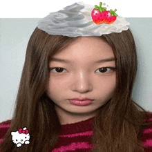 a girl with whipped cream and a strawberry on top of her head
