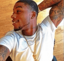 a man with a tattoo on his arm is taking a picture of himself