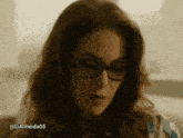 a close up of a woman wearing glasses with the hashtag @ lialmeida05