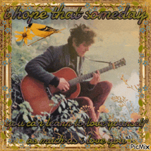 a framed picture of a man playing a guitar with the words " i hope that someday "