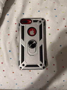 a silver and black iphone case with a red apple logo