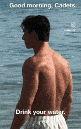 a shirtless man is standing in the water with a caption that says " drink your water "