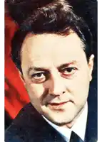 a man 's face is shown with a red background