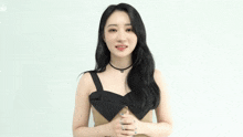 a woman is wearing a choker and a brown dress .
