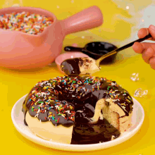 a person is taking a bite out of a donut with chocolate and sprinkles