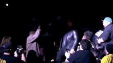a blurry photo of a crowd with a man wearing a shirt that says wb on it