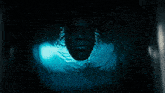 a blurred image of a blue circle with a dark background