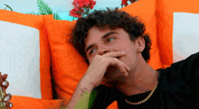 a man with a tattoo of a dollar sign on his forearm