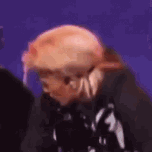 a close up of a person 's face with a purple background
