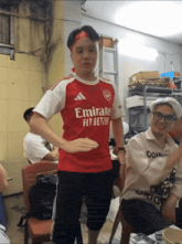 a man wearing an emirates fly better jersey