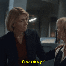 two women are looking at each other with the words " you okay " in yellow