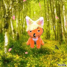 a picture of a stuffed animal in a forest with picmix in the bottom right corner