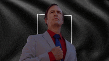 a man in a suit and tie has his fist on his chest