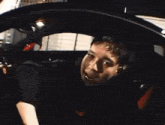 a man in a car with his mouth open