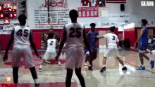 a basketball game is being played in a gym with a score of 3 to 4