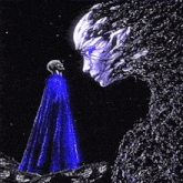 a man in a blue cape stands in front of a giant face